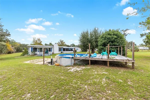 a view of a swimming pool with a yard