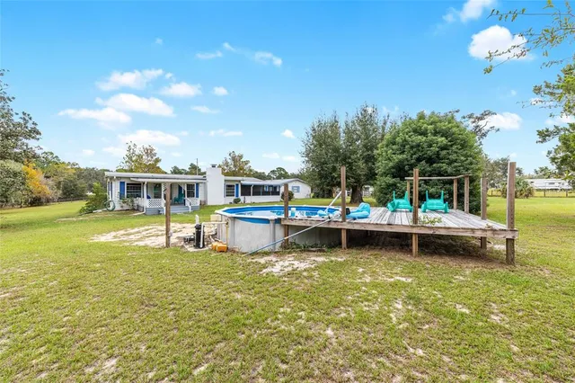 a view of a swimming pool with a yard