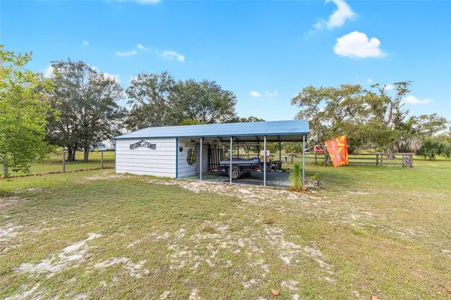a view of a house with a yard balcony and swimming pool