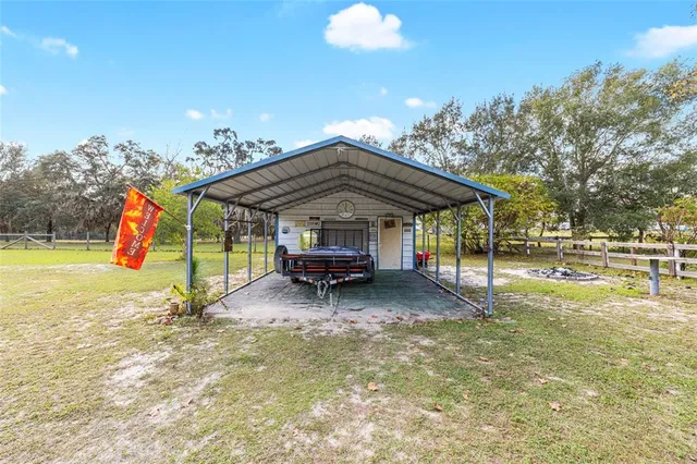 a view of a house with a backyard porch and sitting area