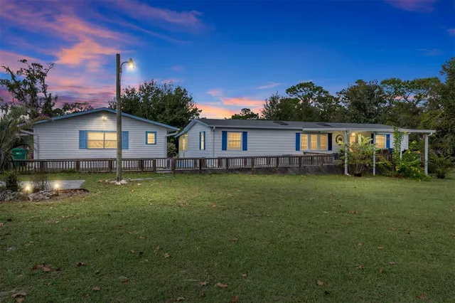 a view of house with outdoor space and swimming pool