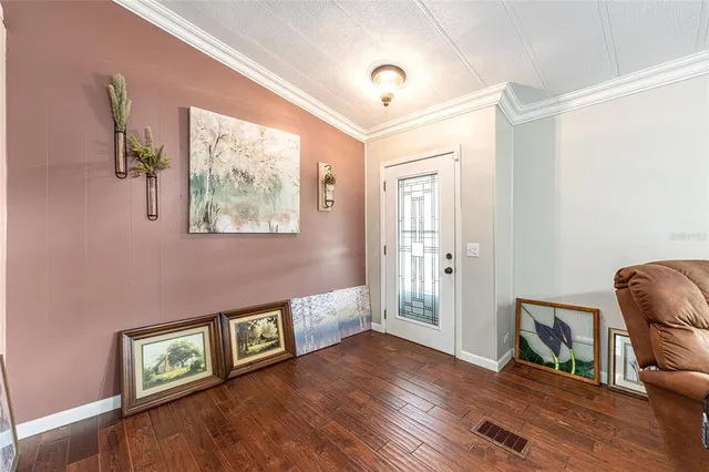 a view of an entryway with wooden floor