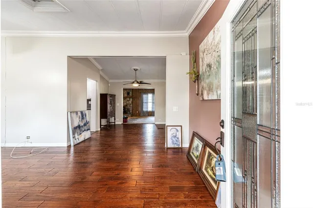 a view of a hallway view with wooden floor and staircase