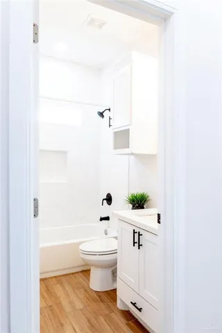 a bathroom with a sink a toilet and bathtub