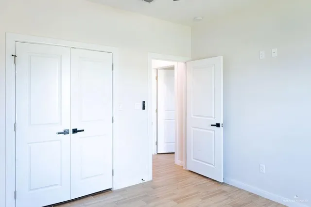 an empty room with wooden floor