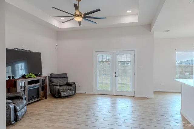 a view of a livingroom with furniture hardwood floor and a ceiling fan