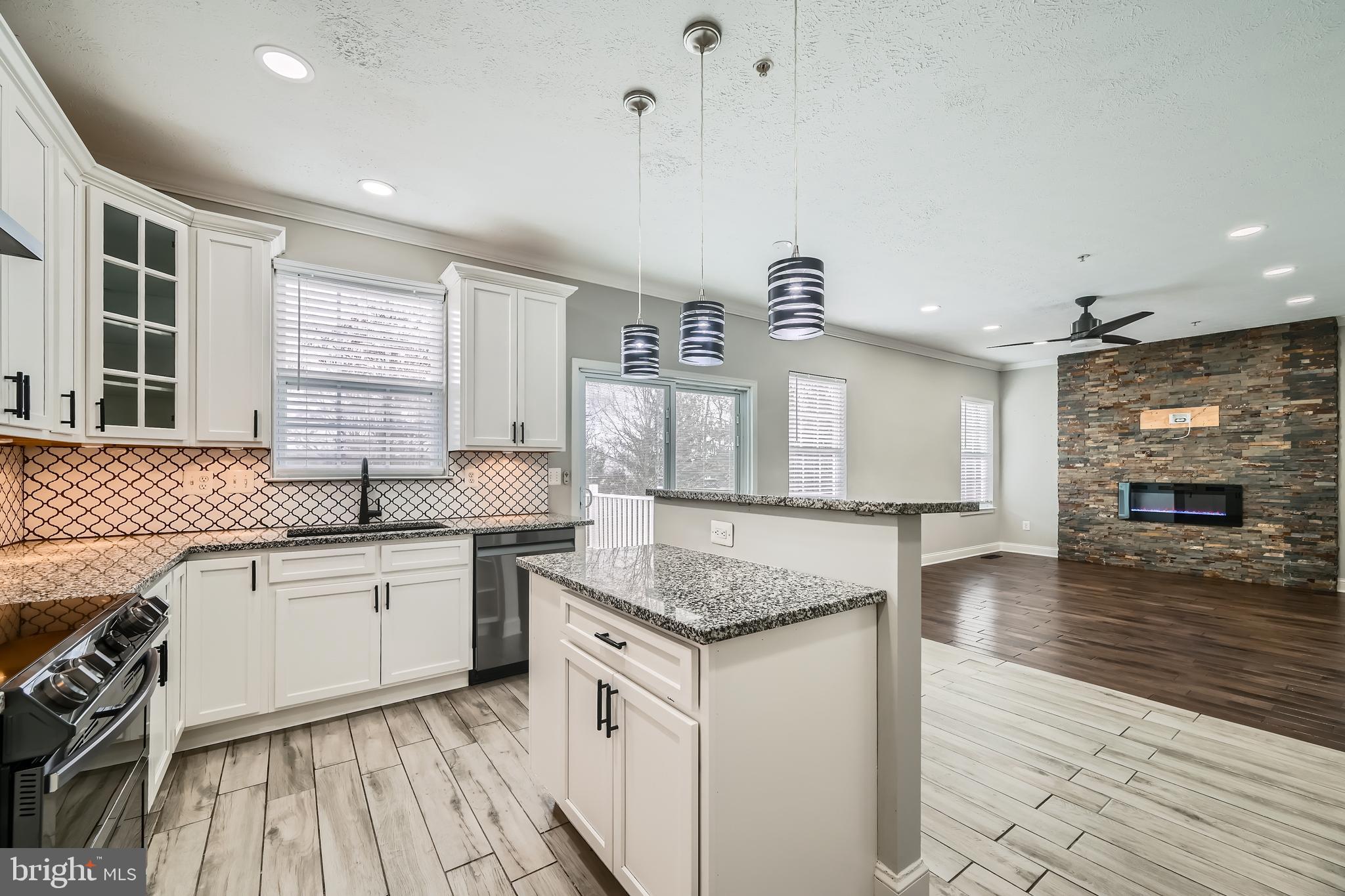 9655 Davison Road Middle River, MD 21220 - Photo 12 of 43 a kitchen with granite countertop a sink stove and cabinets
