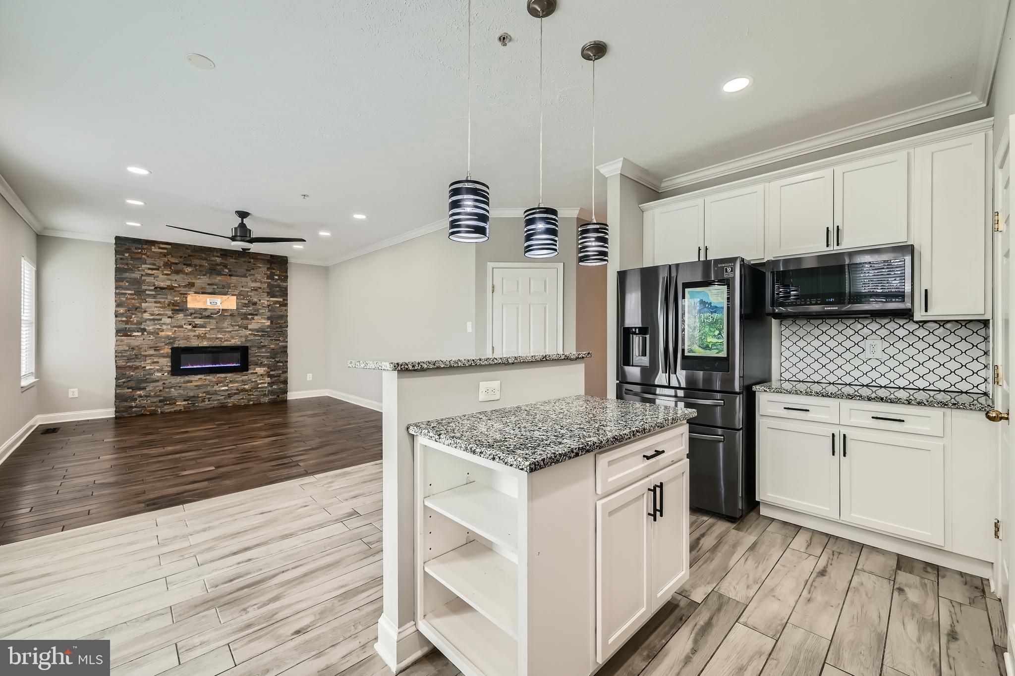9655 Davison Road Middle River, MD 21220 - Photo 13 of 43 a kitchen with stainless steel appliances granite countertop a sink stove and refrigerator