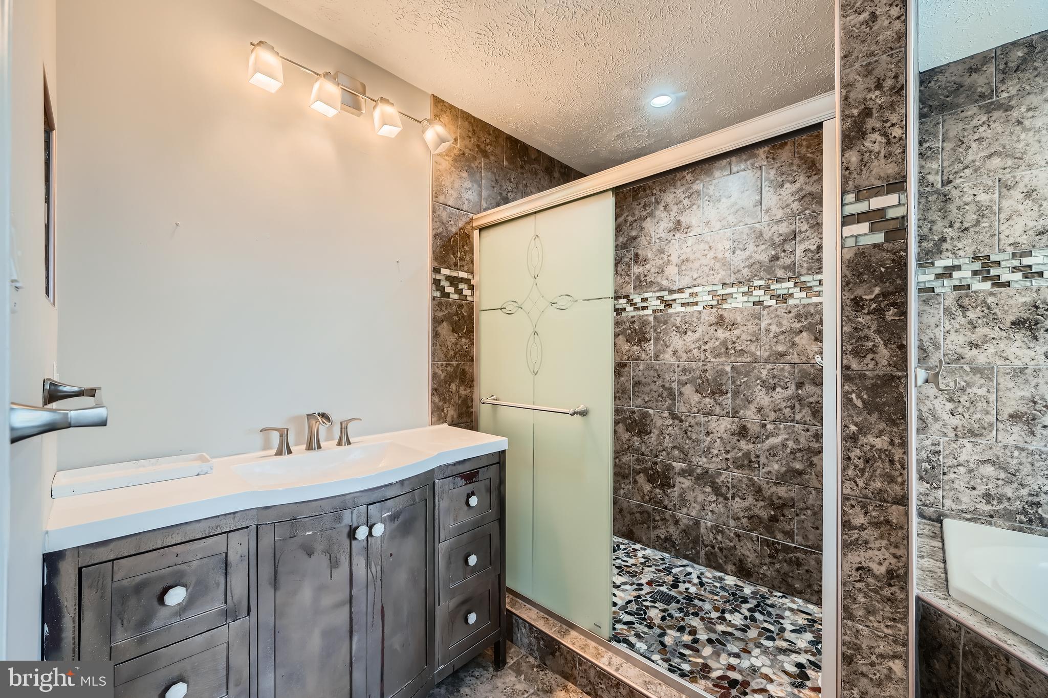 9655 Davison Road Middle River, MD 21220 - Photo 25 of 43 a bathroom with a double vanity sink a toilet a shower and a mirror