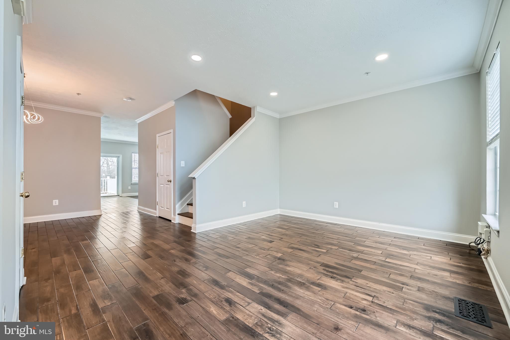 9655 Davison Road Middle River, MD 21220 - Photo 4 of 43 a view of an empty room with wooden floor and stairs