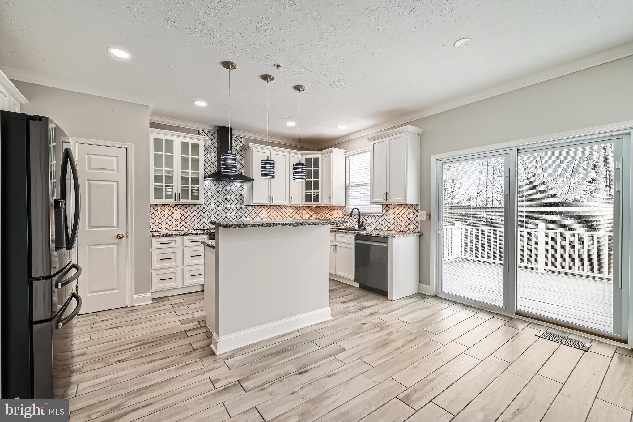 9655 Davison Road Middle River, MD 21220 - Photo 9 of 43 a kitchen with white cabinets and stainless steel appliances