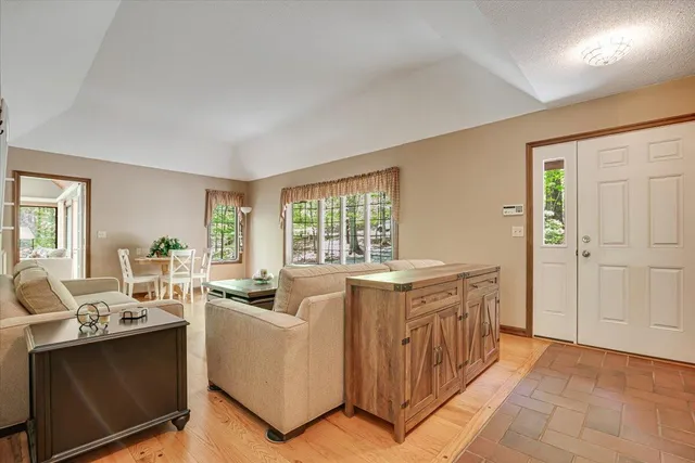 a living room with furniture and large windows