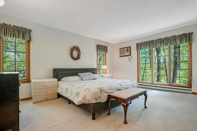 a bedroom with a bed and a painting on the wall