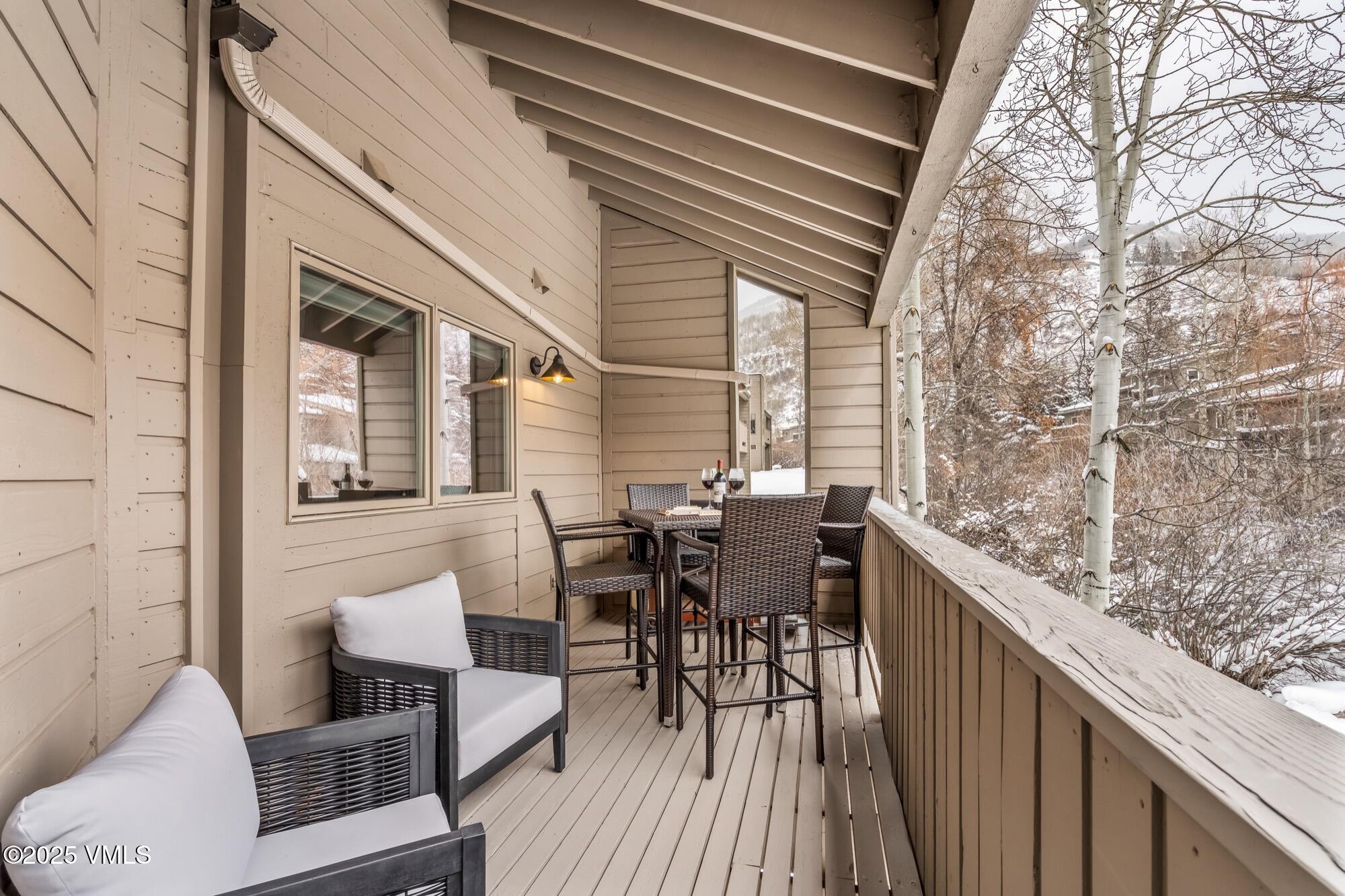 945 Red Sandstone Road, Unit A5 Vail, CO 81657 - Photo 10 of 38 a view of a patio with table and chairs and wooden floor