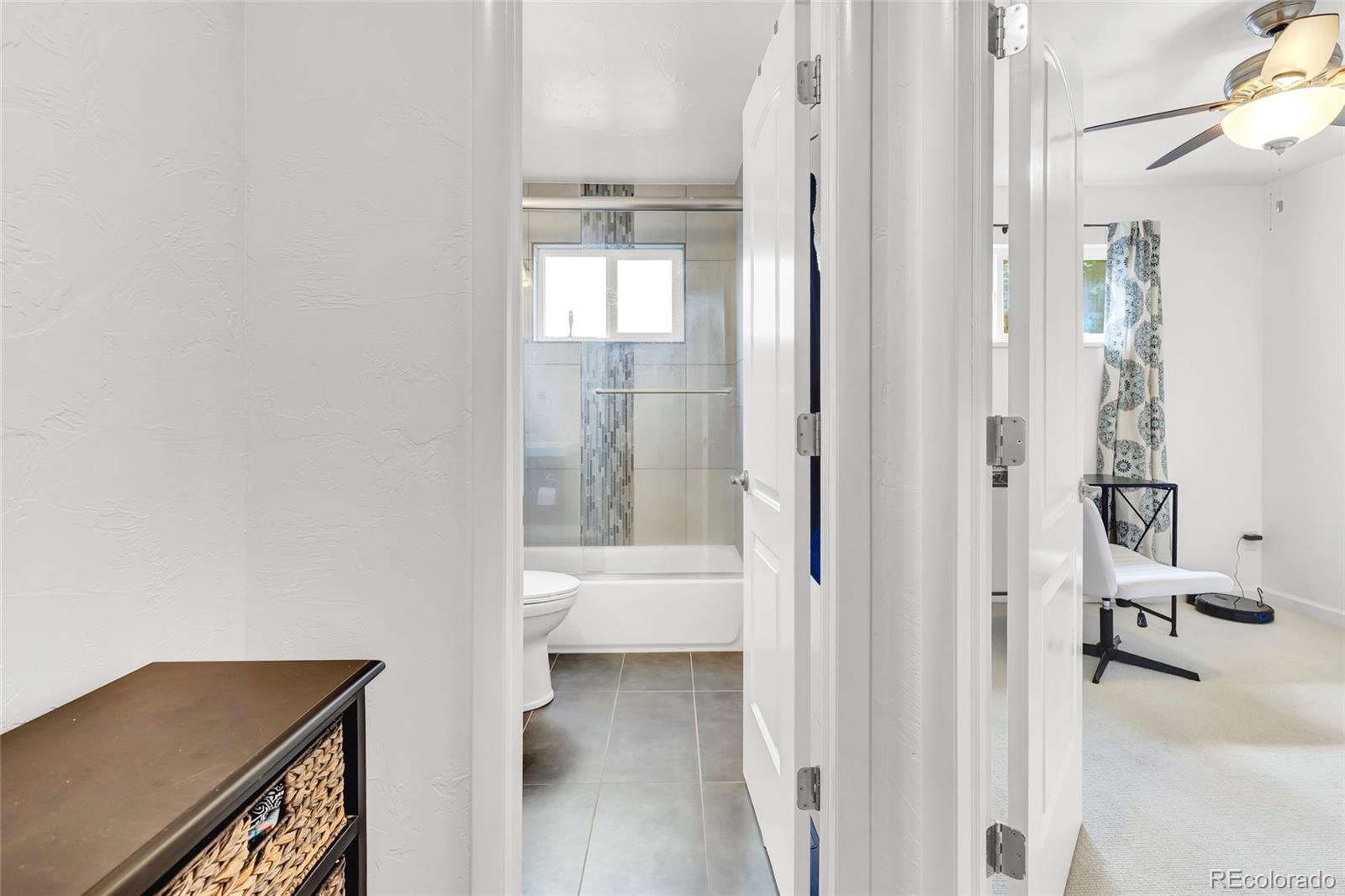 3746 Yates Street Denver, CO 80212 - Photo 13 of 21 a bathroom with a tub shower and a sink