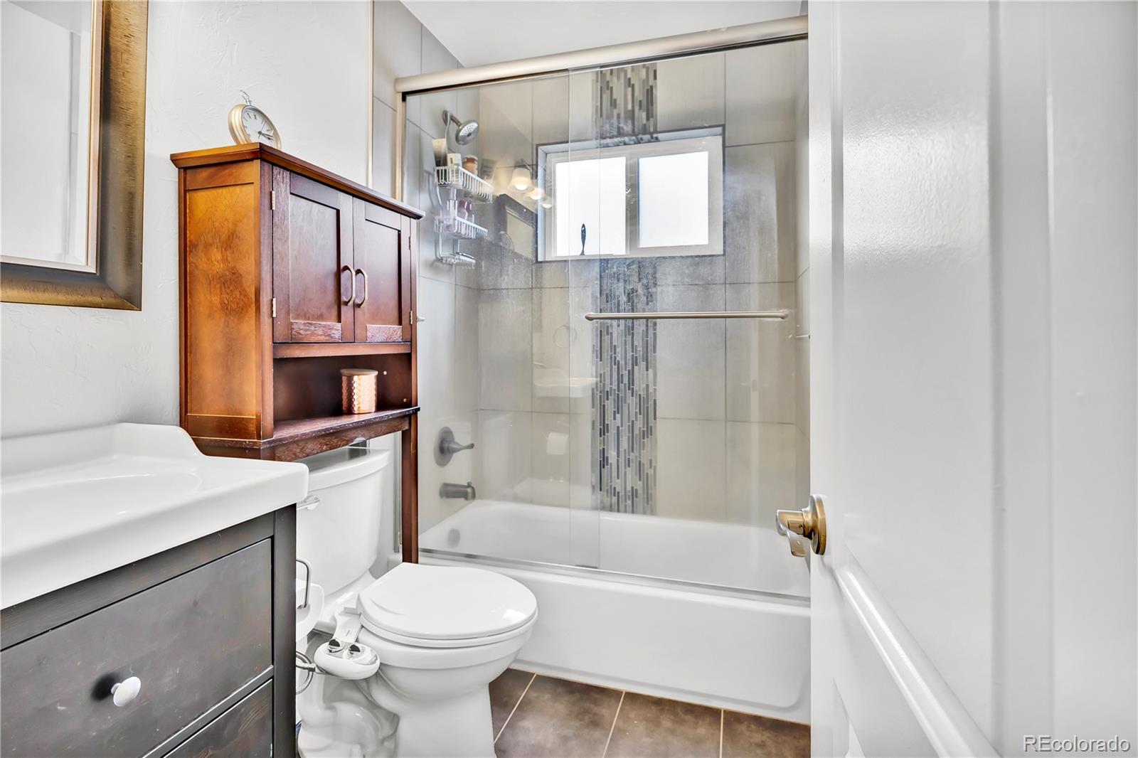 3746 Yates Street Denver, CO 80212 - Photo 14 of 21 a bathroom with a sink toilet and shower