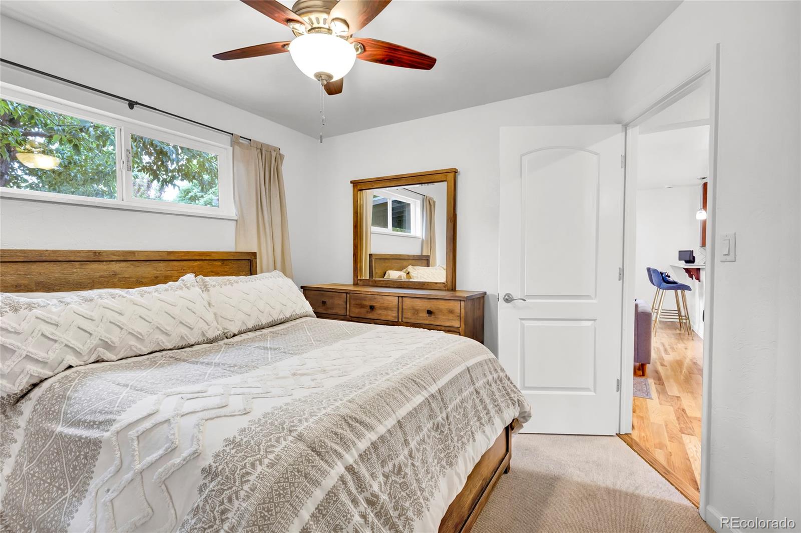 3746 Yates Street Denver, CO 80212 - Photo 9 of 21 a bedroom with a large bed and a chandelier