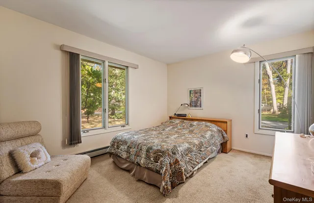a bedroom with a bed couch and window