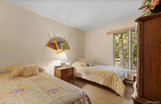 a bedroom with two beds and a window