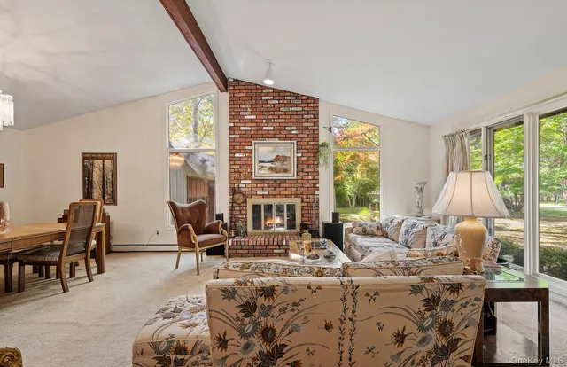 a living room with furniture and large windows