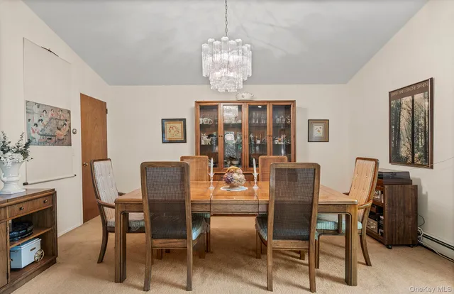 a dining room with furniture a chandelier and window