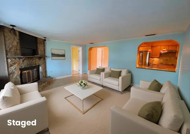 a living room with furniture a rug and a flat screen tv