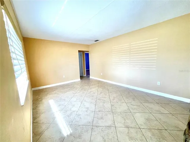 a view of an empty room with a window