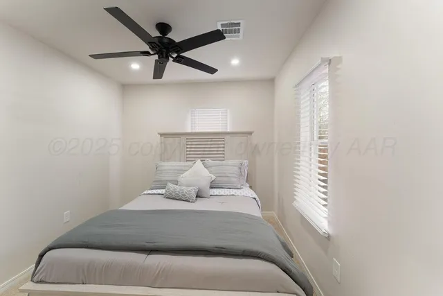 a bedroom with a bed and window