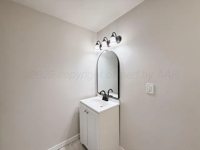 a bathroom with a sink and mirror