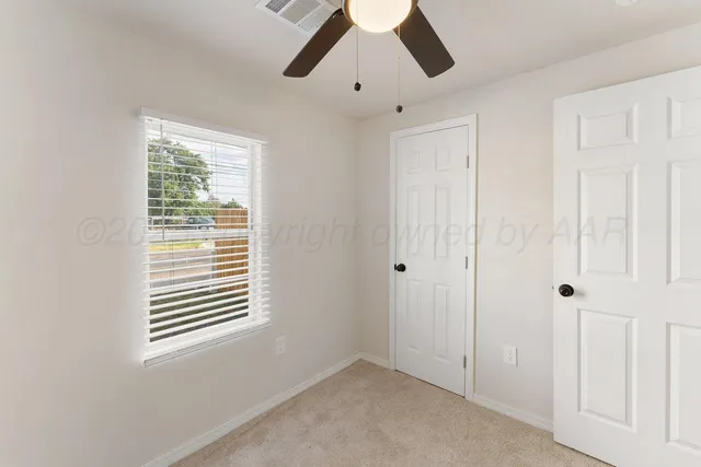 a view of an empty room with a window