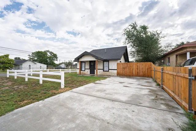 a view of house with swimming pool and sitting area