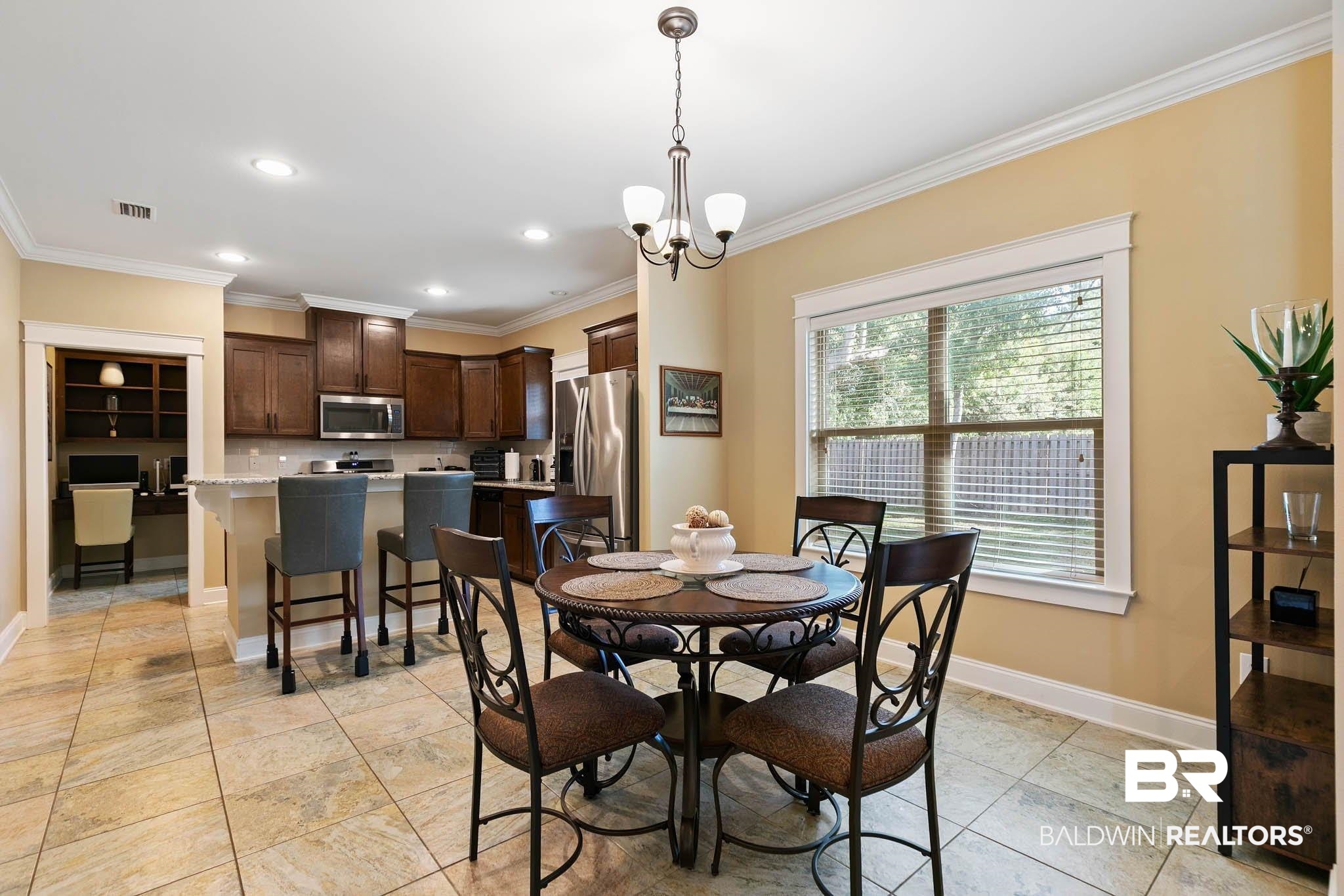 19740 Bunker Loop Fairhope, AL 36532 - Photo 9 of 33 Dining area featuring ornamental molding, a chandelier, and recessed lighting