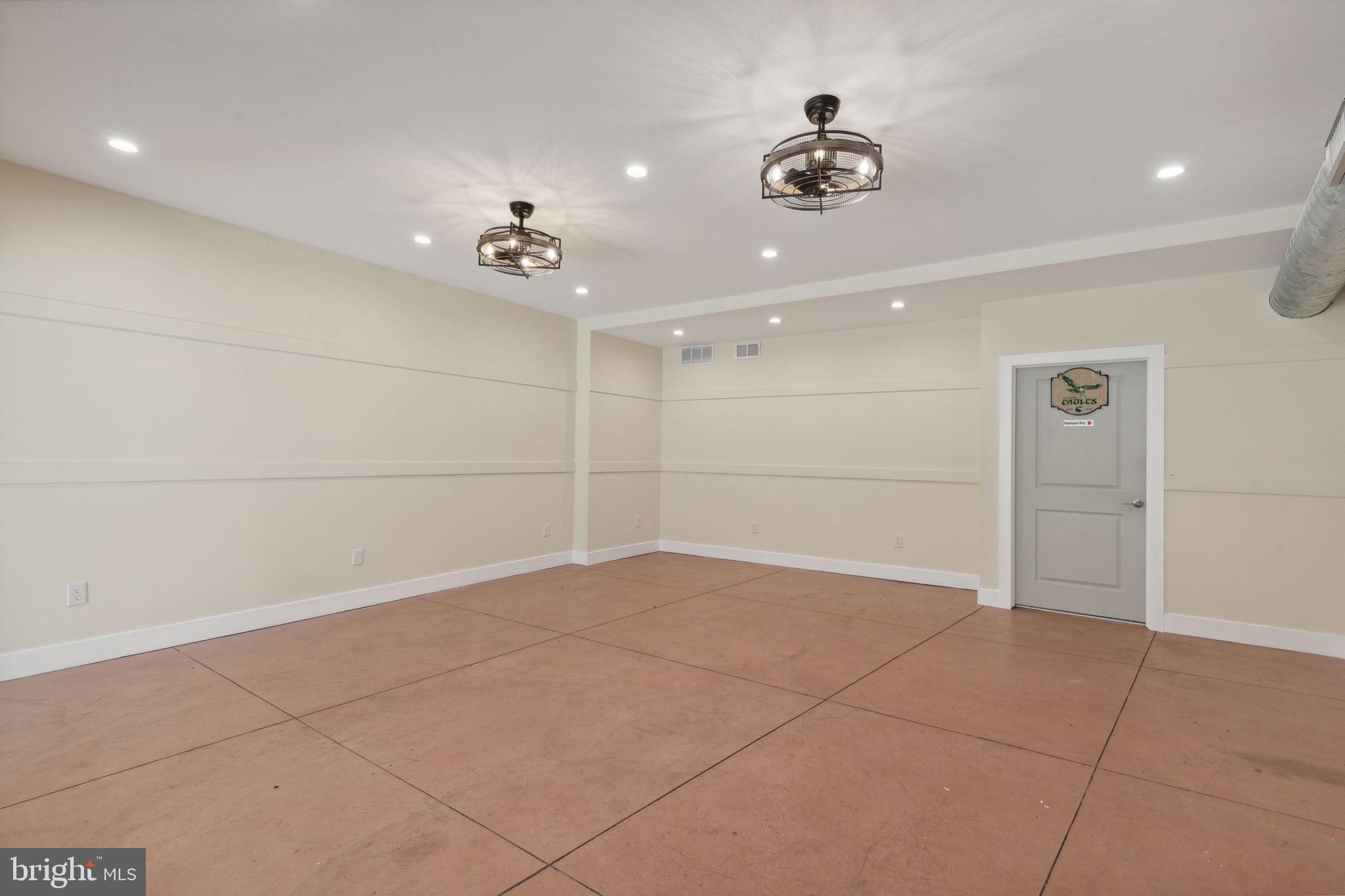 5460 Ridge Avenue Philadelphia, PA 19128 - Photo 17 of 26 an empty room with a ceiling fan and view of a bathroom
