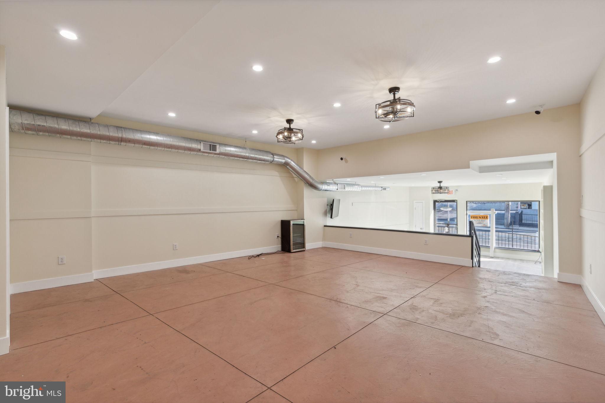 5460 Ridge Avenue Philadelphia, PA 19128 - Photo 18 of 26 a view of a livingroom with kitchen and chandelier