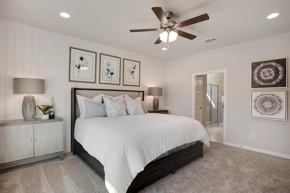 126 Georgia Lace Trail Georgetown, TX 78626 - Photo 13 of 32 a bedroom with a large bed and a chandelier
