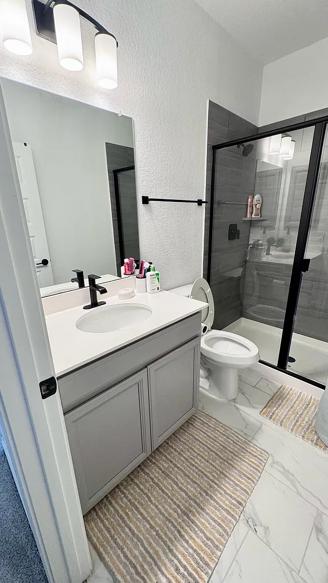126 Georgia Lace Trail Georgetown, TX 78626 - Photo 21 of 32 a bathroom with a sink mirror vanity and toilet