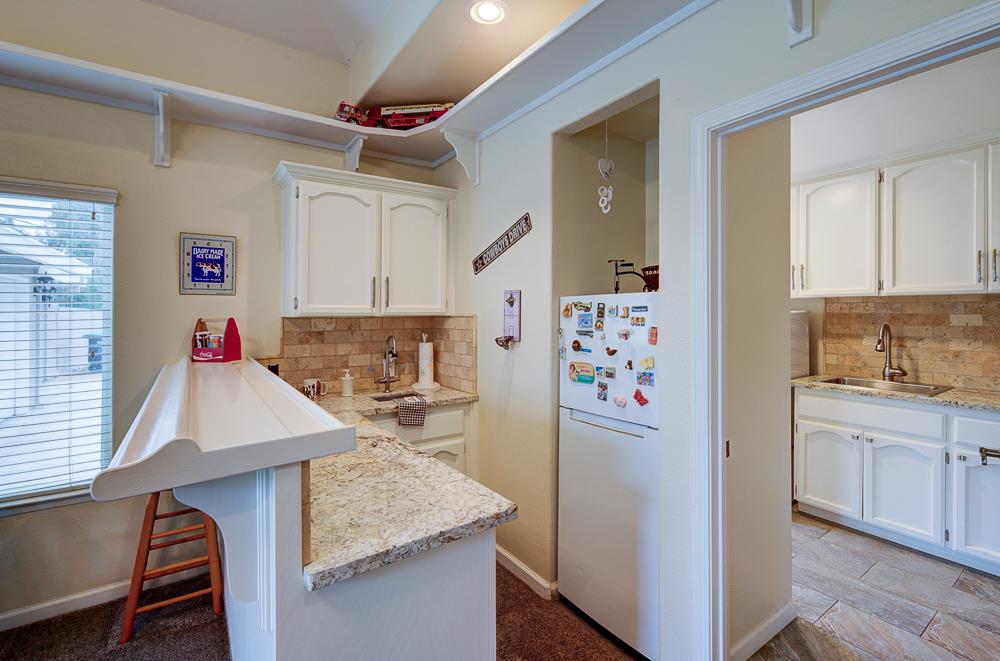 17465 Monreal Road Madera, CA 93636 - Photo 30 of 59 a kitchen with stainless steel appliances granite countertop a refrigerator and a stove top oven