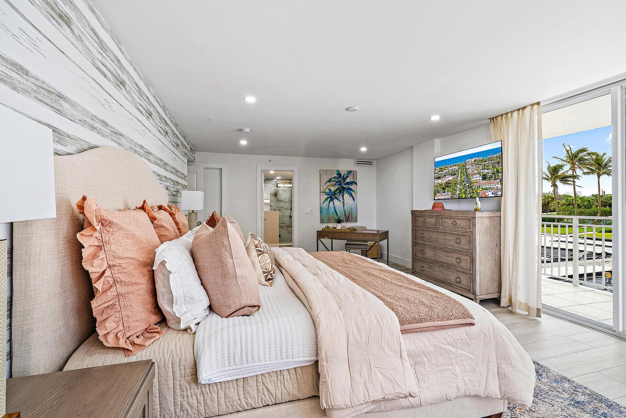 500 Ocean Drive, Unit E2A Juno Beach, FL 33408 - Photo 12 of 40 a bed room with a bed and a chair