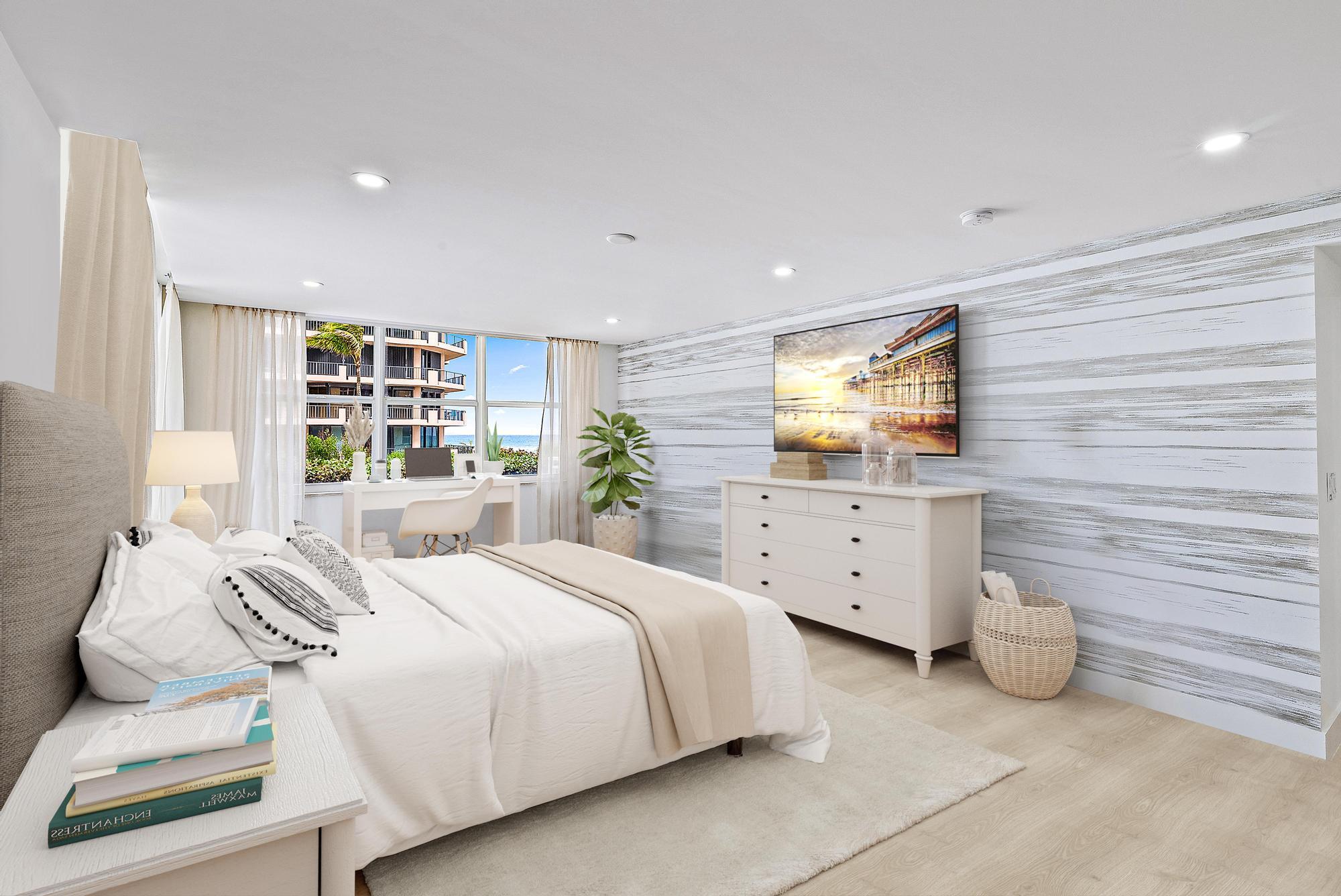 500 Ocean Drive, Unit E2A Juno Beach, FL 33408 - Photo 13 of 40 a spacious bedroom with a bed and a flat screen tv