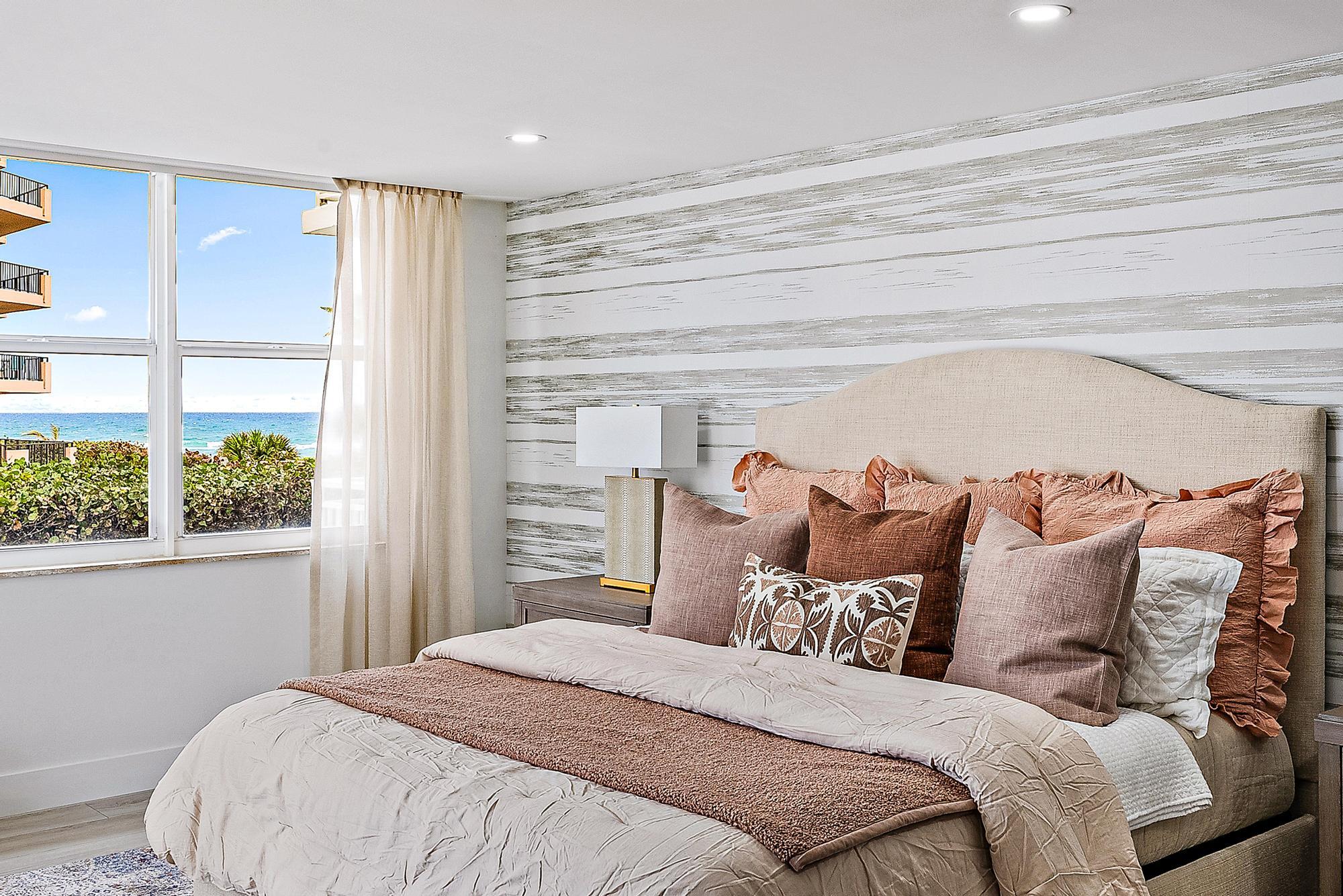 500 Ocean Drive, Unit E2A Juno Beach, FL 33408 - Photo 14 of 40 a bedroom with a bed and a window