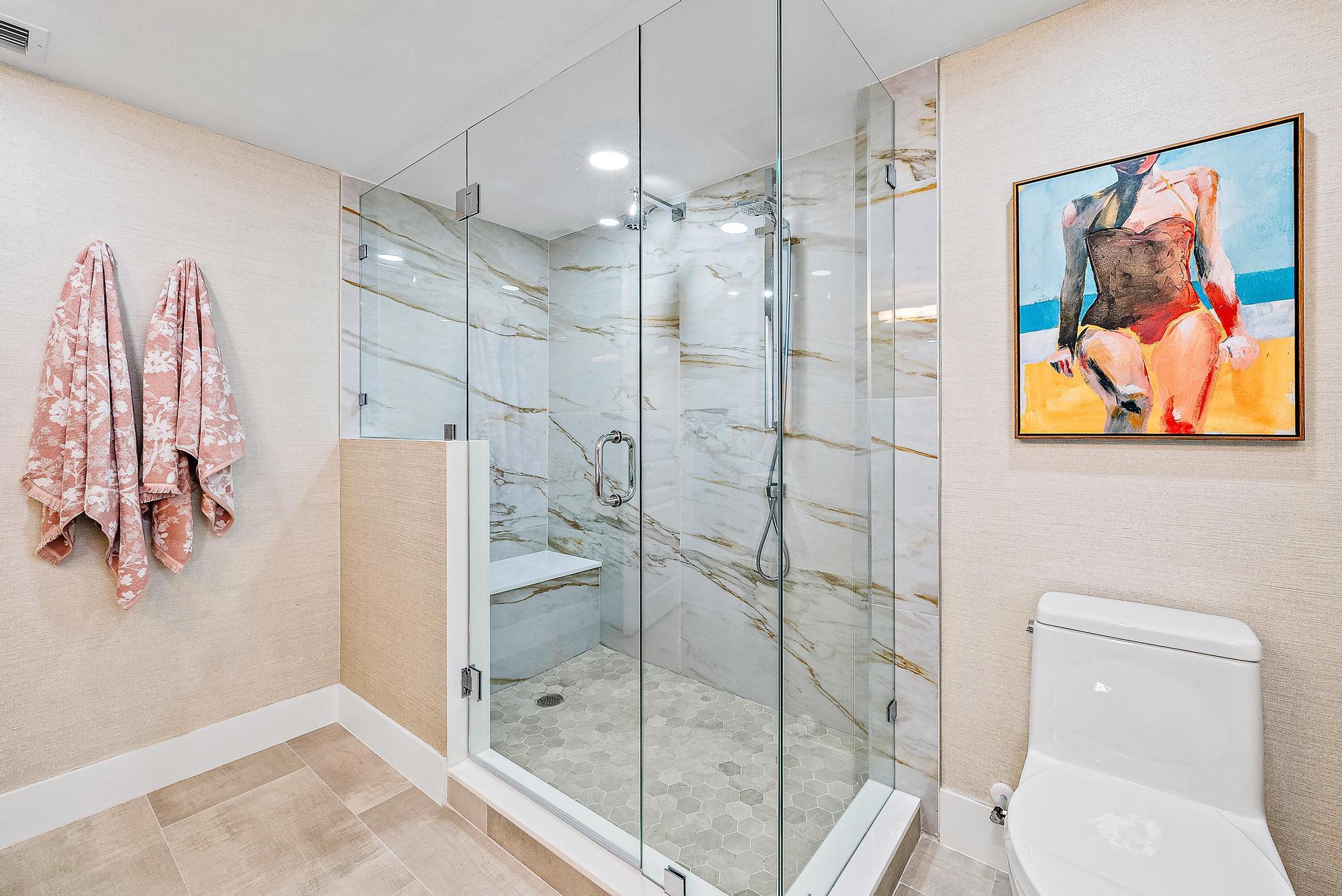 500 Ocean Drive, Unit E2A Juno Beach, FL 33408 - Photo 16 of 40 a bathroom with a shower and toilet