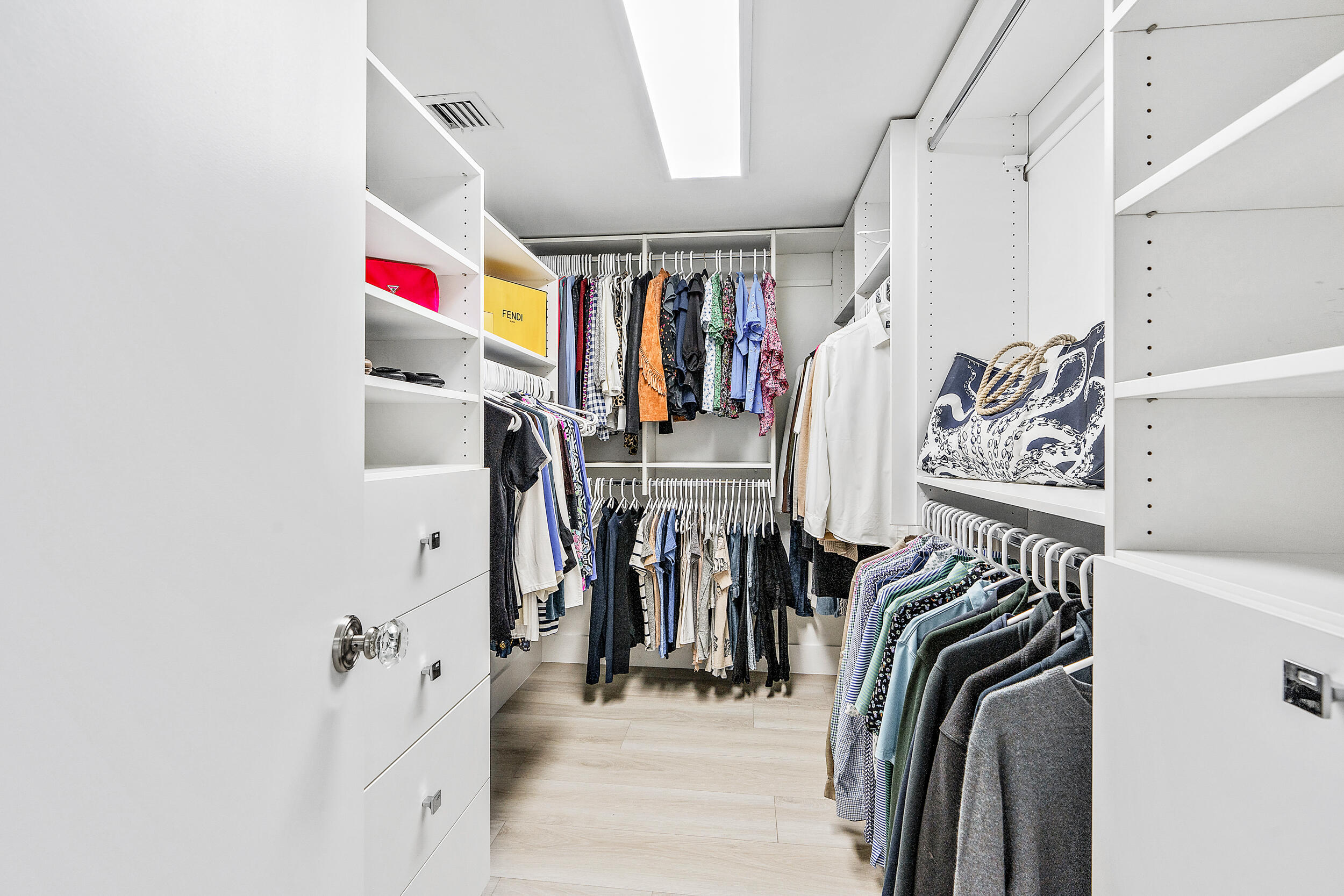 500 Ocean Drive, Unit E2A Juno Beach, FL 33408 - Photo 18 of 40 a view of walk in closet with clothes and shoes