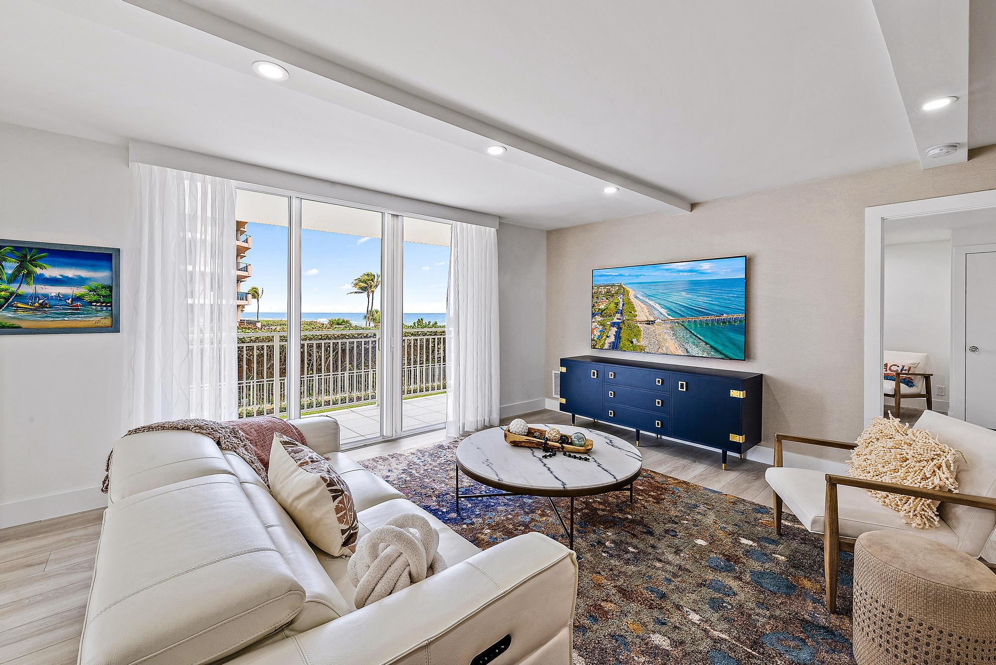 500 Ocean Drive, Unit E2A Juno Beach, FL 33408 - Photo 27 of 40 a living room with furniture and a floor to ceiling window