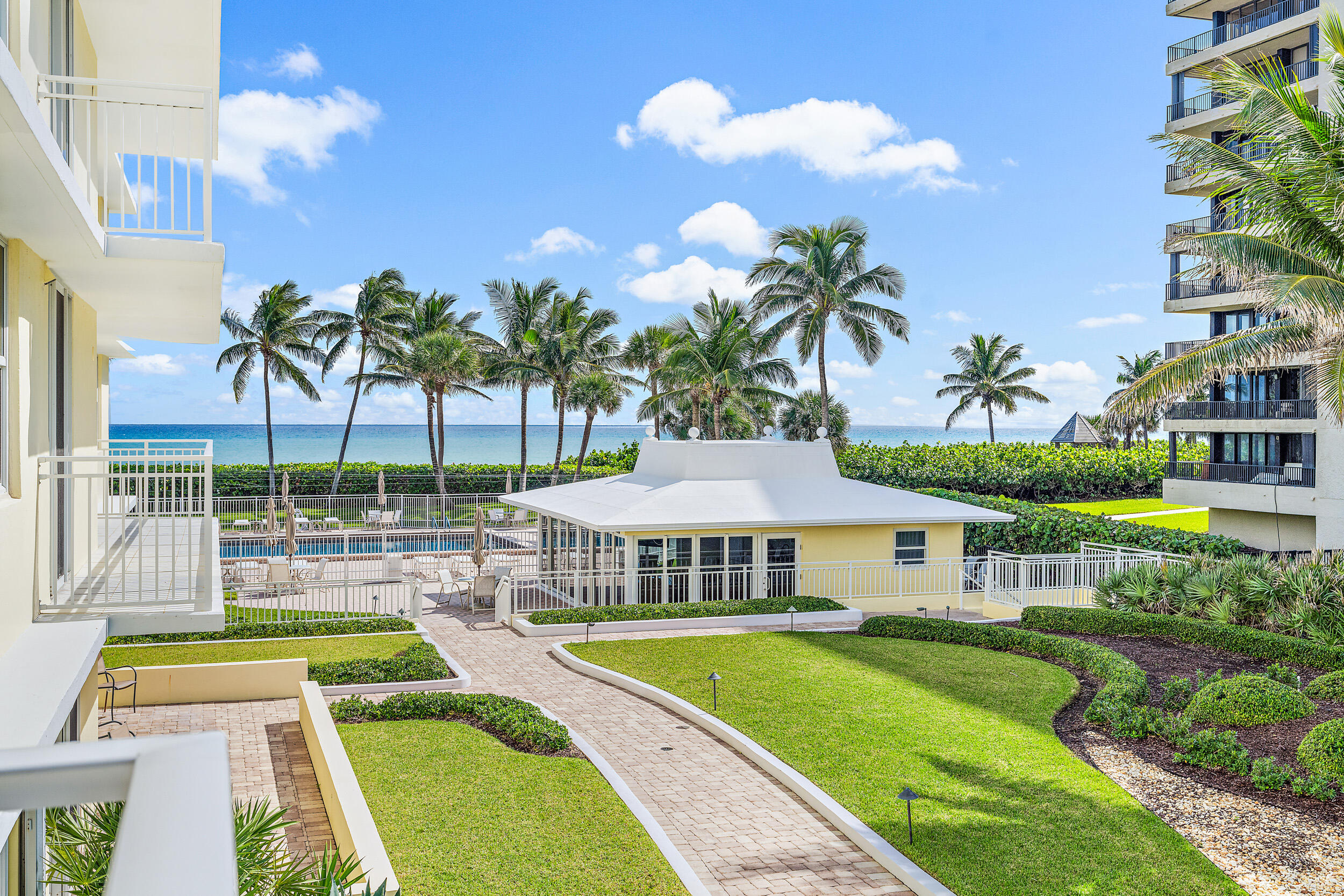 500 Ocean Drive, Unit E2A Juno Beach, FL 33408 - Photo 29 of 40 a view of a house with swimming pool and porch with furniture