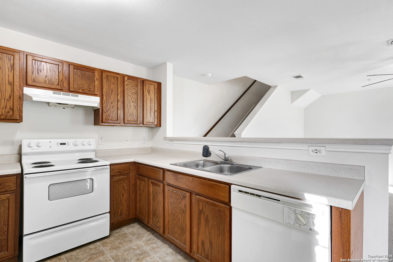 10023 Vasso View, Unit 1 Converse, TX 78109 - Photo 11 of 27 a kitchen with a sink stove and cabinets