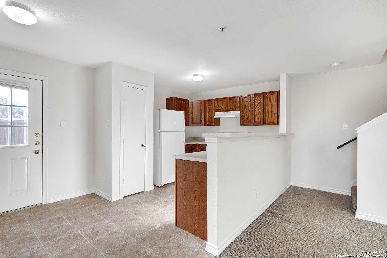10023 Vasso View, Unit 1 Converse, TX 78109 - Photo 12 of 27 a view of a kitchen with refrigerator and a sink