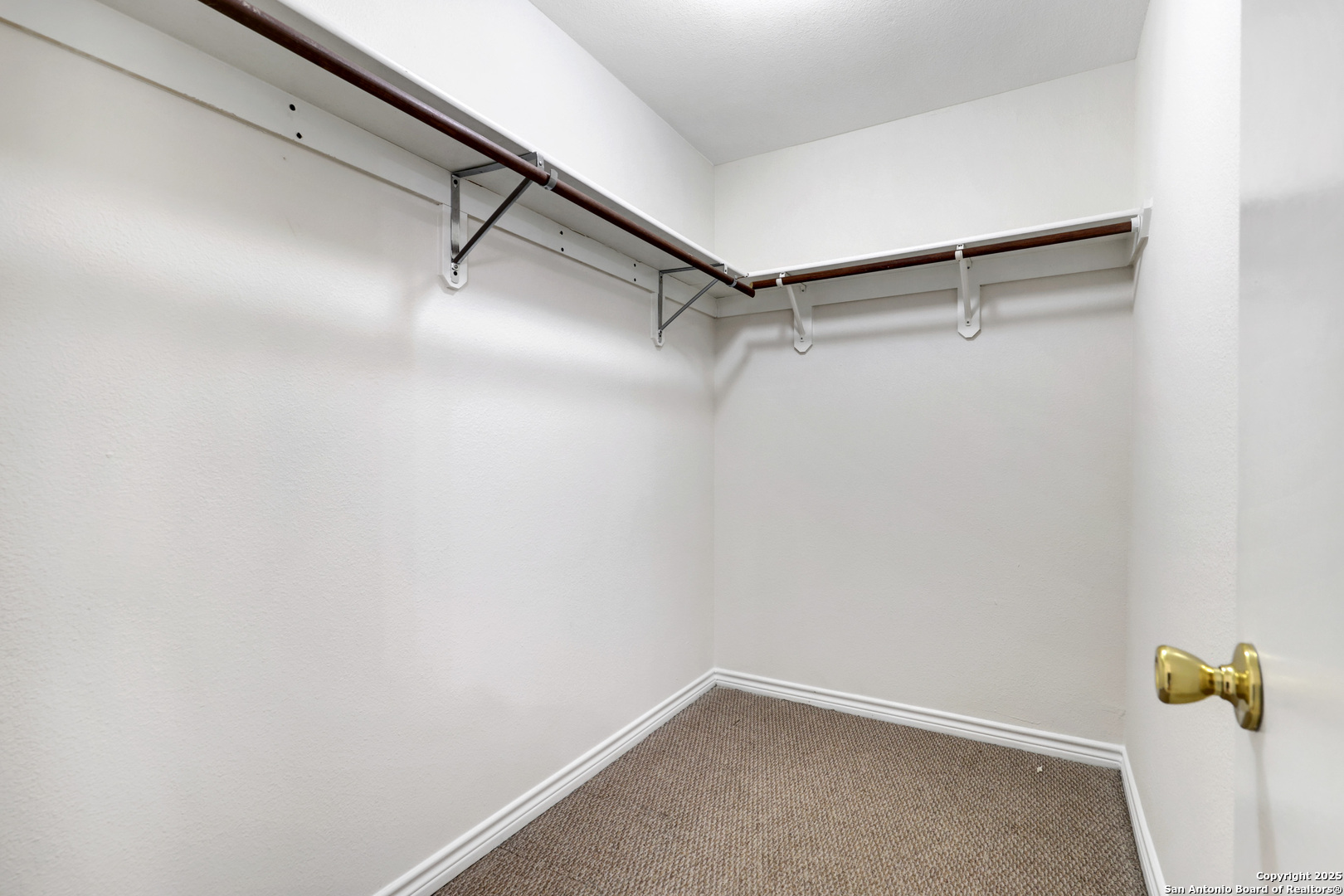10023 Vasso View, Unit 1 Converse, TX 78109 - Photo 18 of 27 a view of walk in closet with empty racks