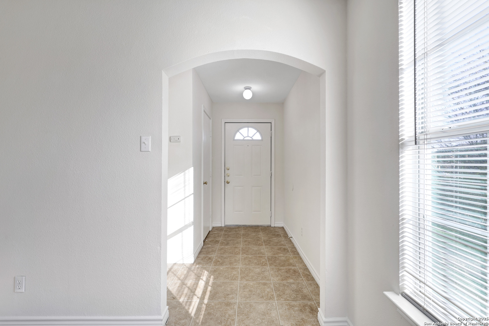 10023 Vasso View, Unit 1 Converse, TX 78109 - Photo 2 of 27 a view of a hallway with wooden floor and a window