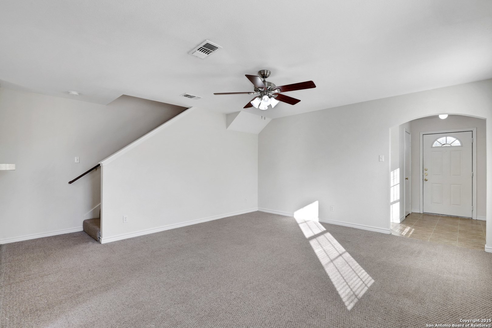 10023 Vasso View, Unit 1 Converse, TX 78109 - Photo 6 of 27 a view of a livingroom with a ceiling fan and window