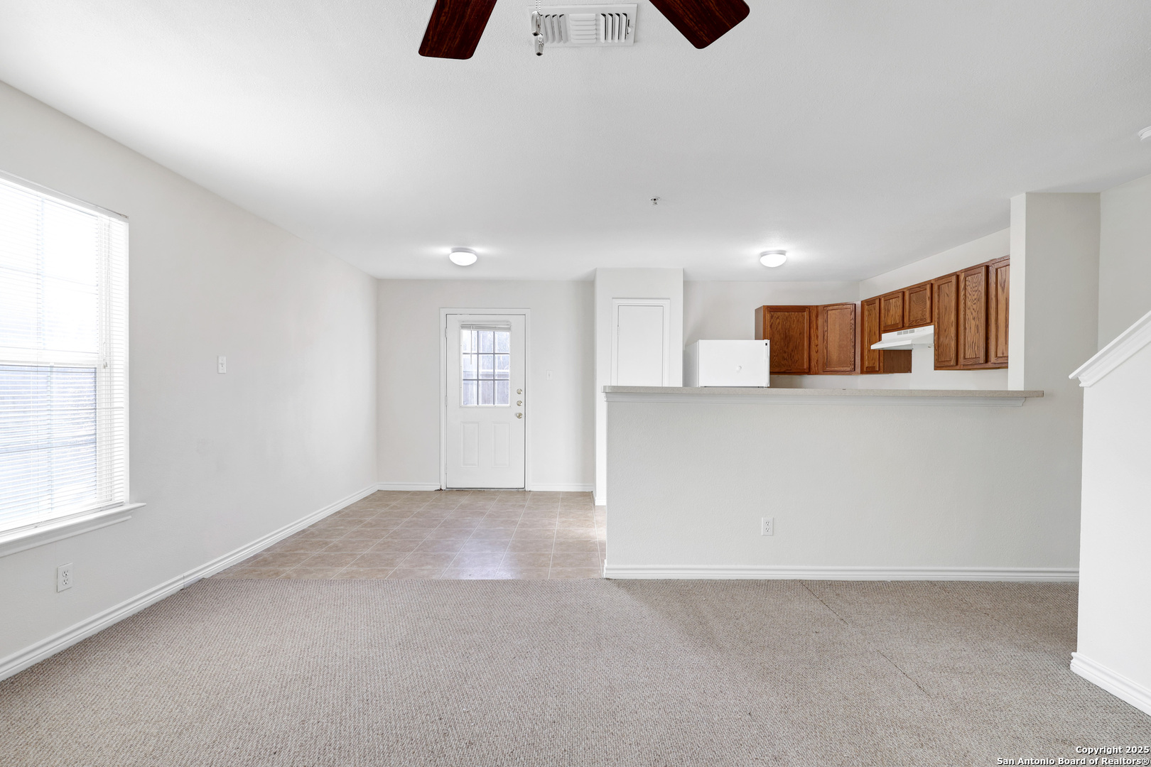 10023 Vasso View, Unit 1 Converse, TX 78109 - Photo 7 of 27 a view of an empty room with window and wooden floor